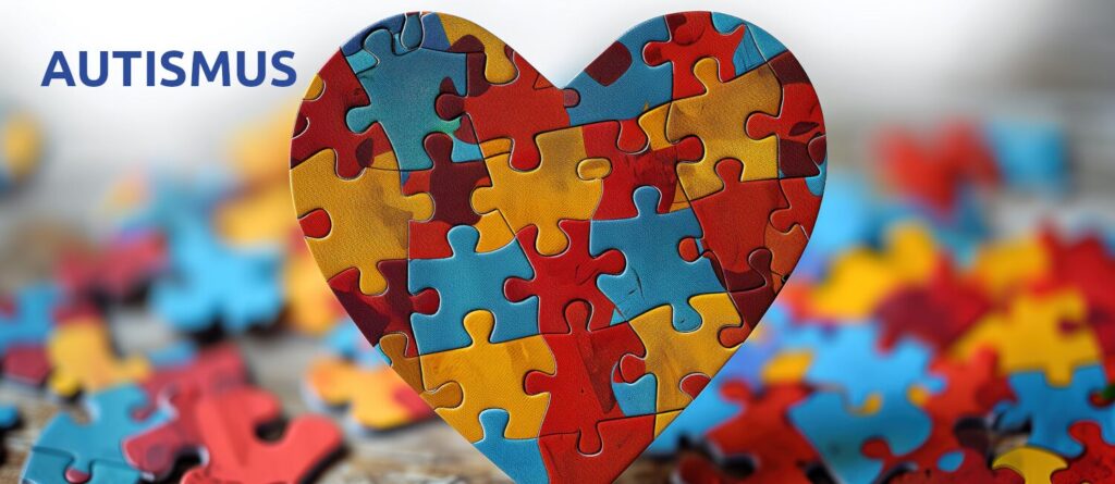 Ein aufrecht stehendes Herz aus Puzzle-Teilen, die die Farben des Welt-Autismus-Tages tragen.